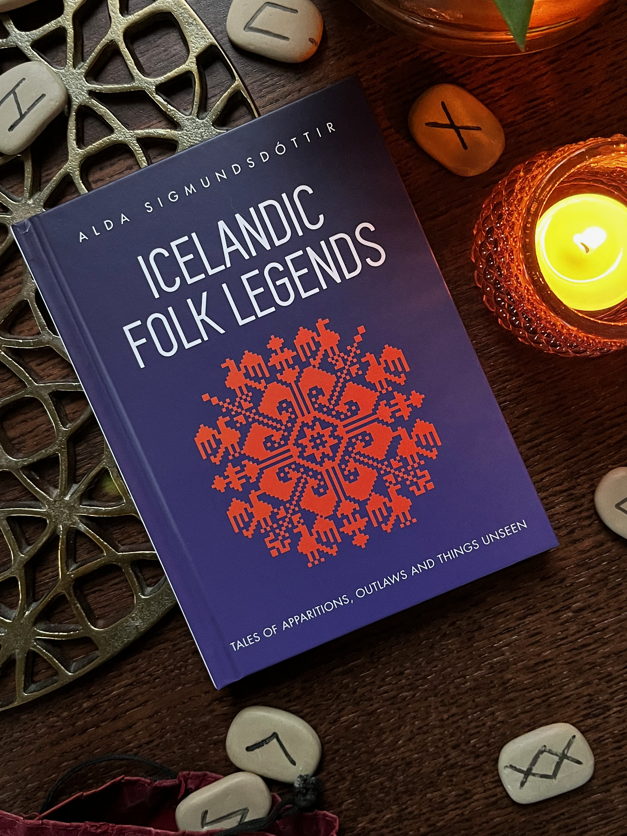 Two copies of Icelandic Folk Legends lying on a table next to a plant